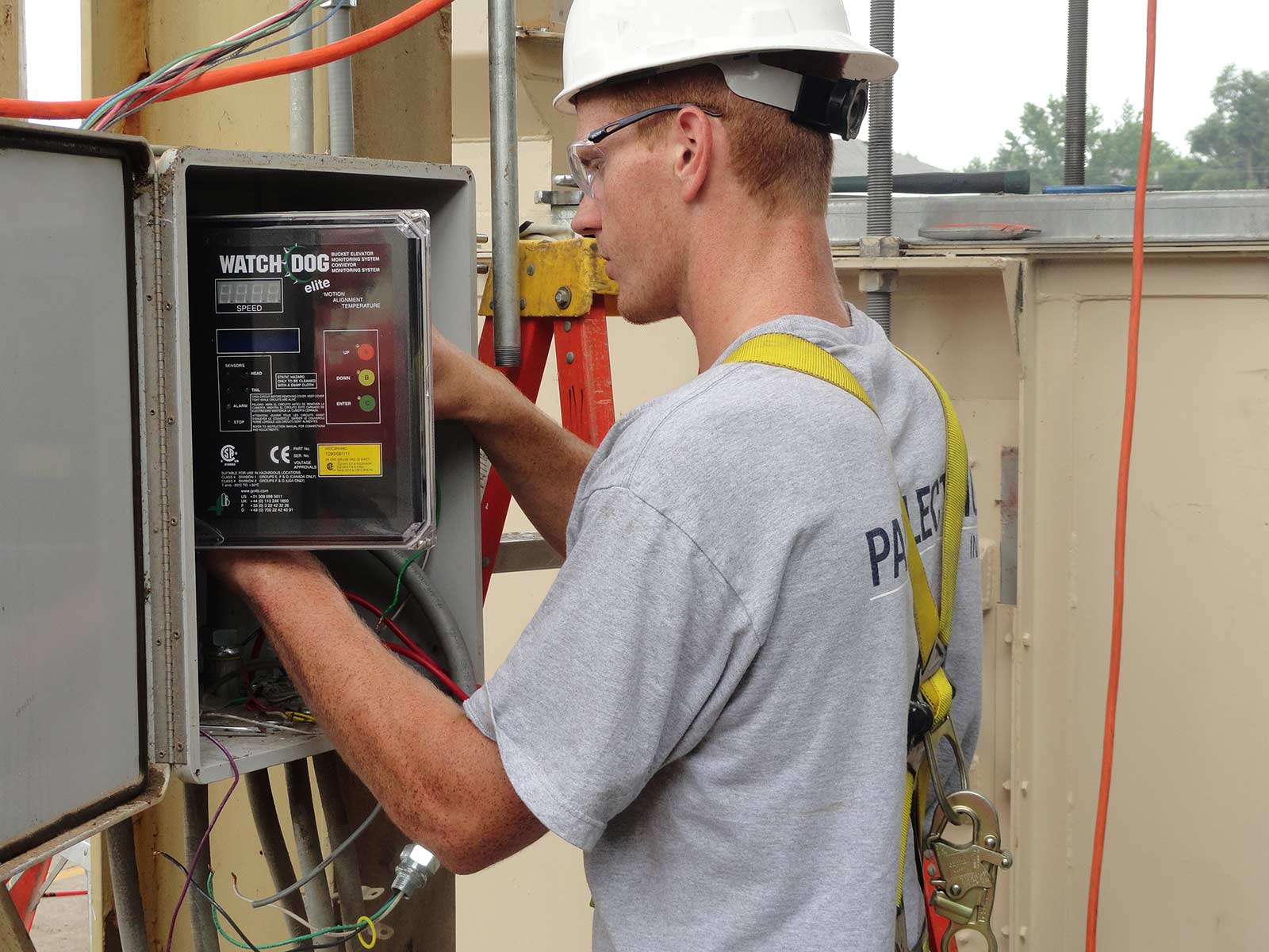 Pals Electric electrician working on an automation controls system in a service panel