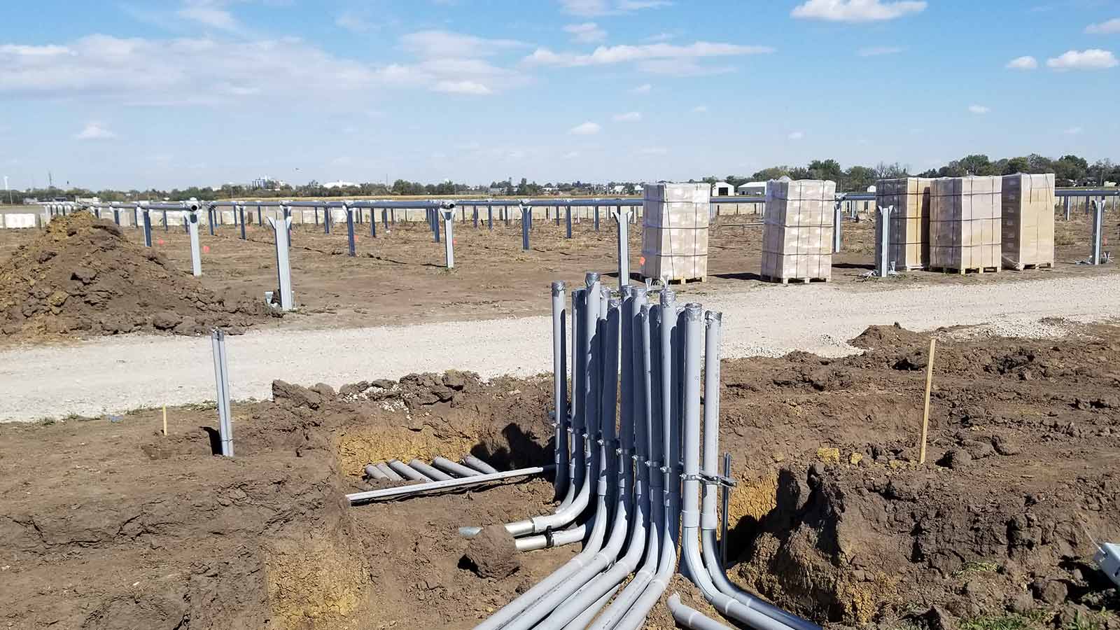 view three of conduit during installation phase under a solar panel