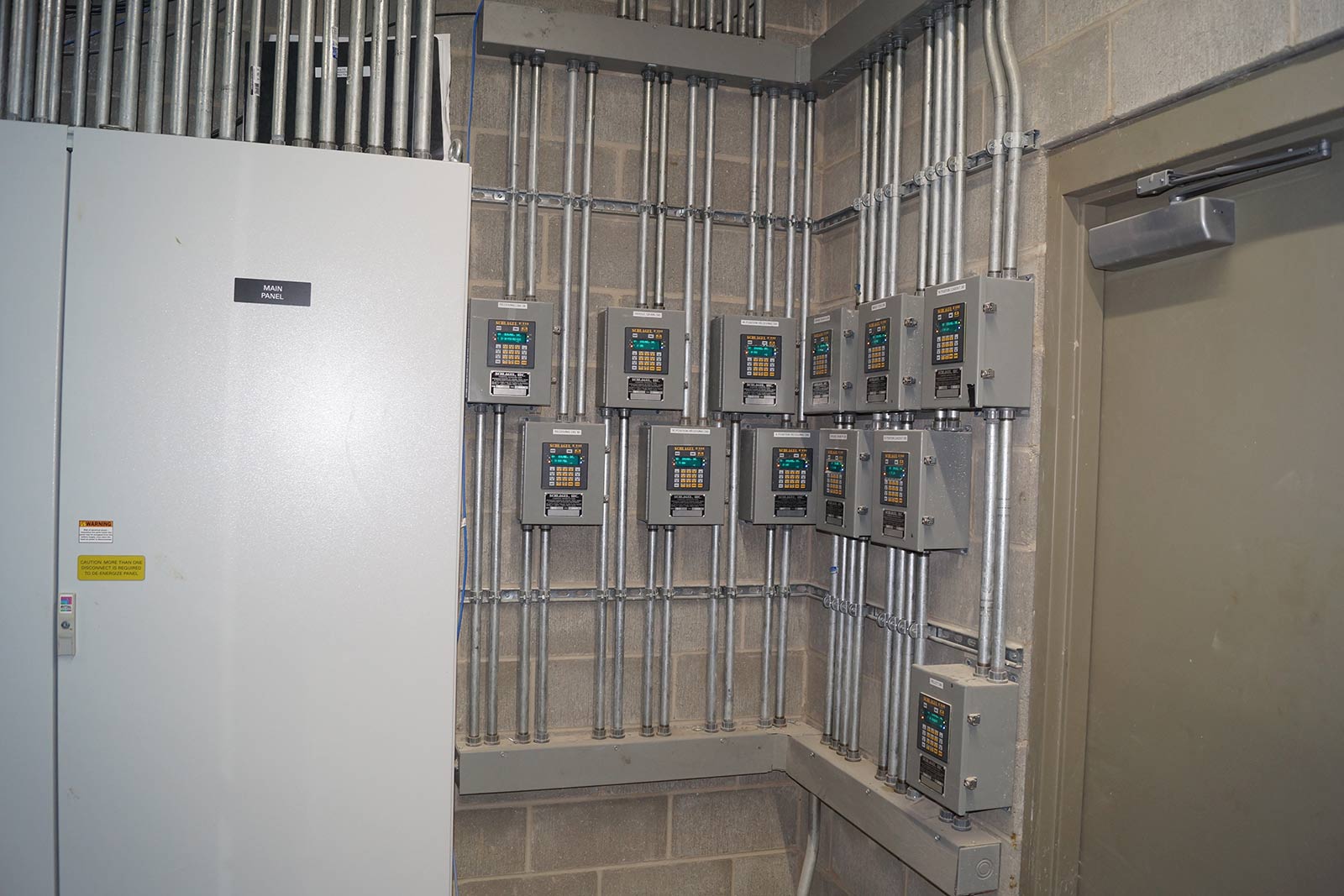 electric panels, breakers, and conduit inside a room at the Effingham feed mill