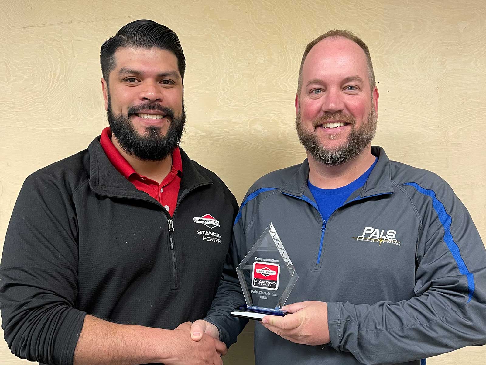 Matt Pals accepting the 2021 Diamond Dealer Award from a Briggs and Stratton representative