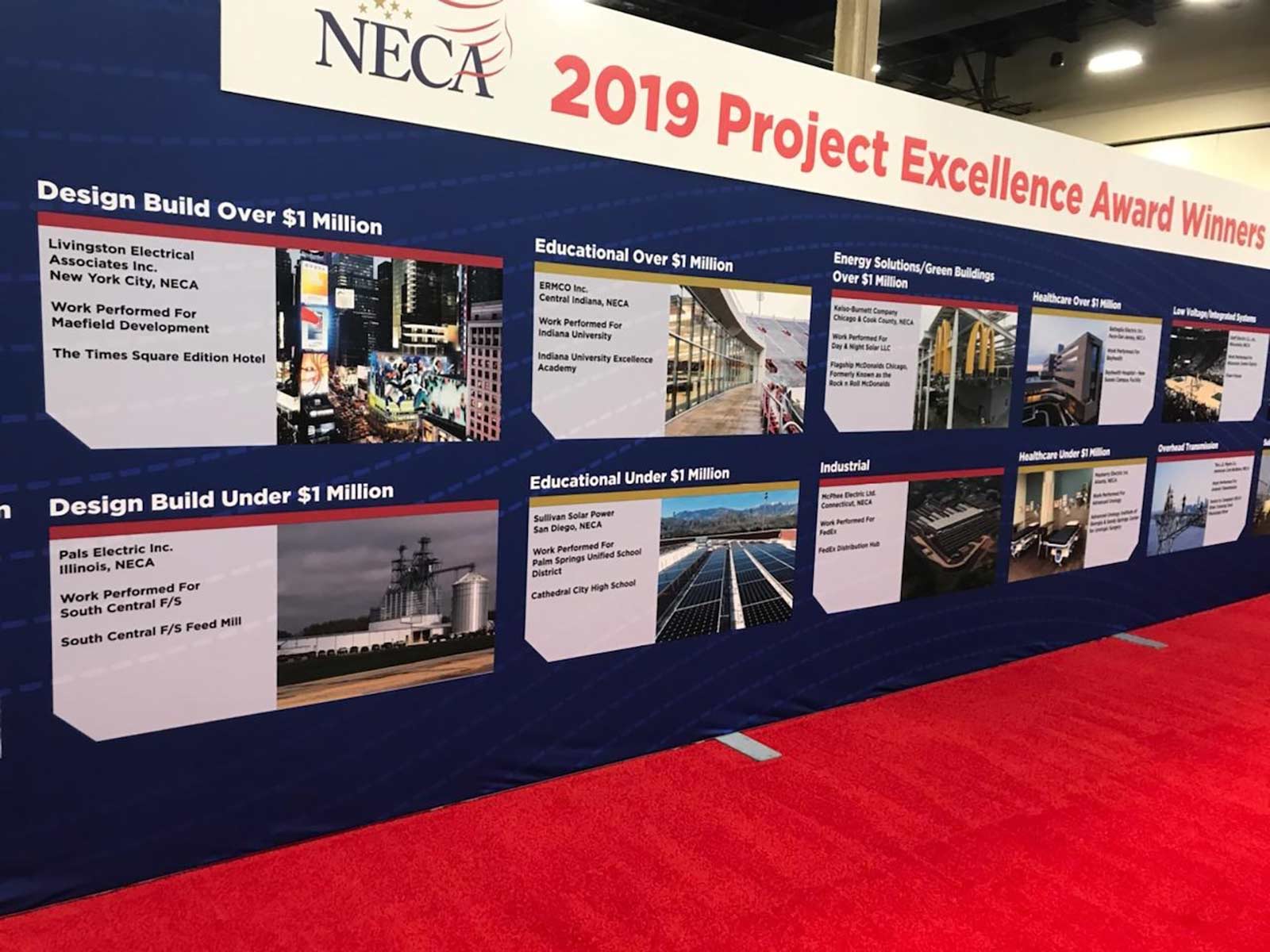 a N E C A Project Excellence wall banner showing Pals Electric winning for a Design Build Under $1 million